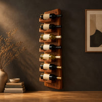 Slim vertical wine rack with seven angled cradles on a tall wooden board in a dark studio against a charcoal plaster wall