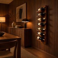 Slim vertical wine rack with seven angled cradles on a tall wooden board in an evening dining room with walnut wall paneling