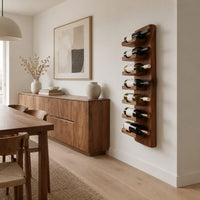 Slim vertical wine rack with seven angled cradles on a tall wooden board in a Scandinavian dining room with white walls