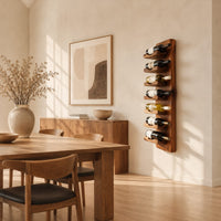 Slim vertical wine rack with seven angled cradles on a tall wooden board in a bright open plan dining room