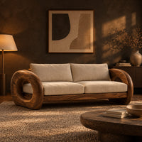 Wood sofa with open ring arms and two wide seat cushions in a dark living room at golden hour
