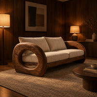Wood sofa with open ring arms and two wide seat cushions in an evening living room with walnut wall paneling