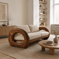 Wood sofa with open ring arms and two wide seat cushions in a Scandinavian living room with white walls