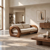 Wood sofa with open ring arms and two wide seat cushions in a bright open plan living room