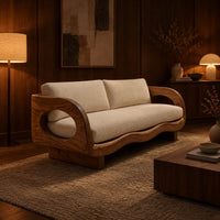 Sofa with oval arm openings, a wavy wooden frame and pale seat cushions in an evening living room with walnut wall paneling