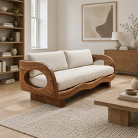 Sofa with oval arm openings, a wavy wooden frame and pale seat cushions in a Scandinavian living room with white walls