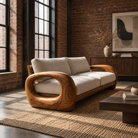 Sofa with thick open loop wooden arms and two seat cushions in an industrial loft living room with exposed brick