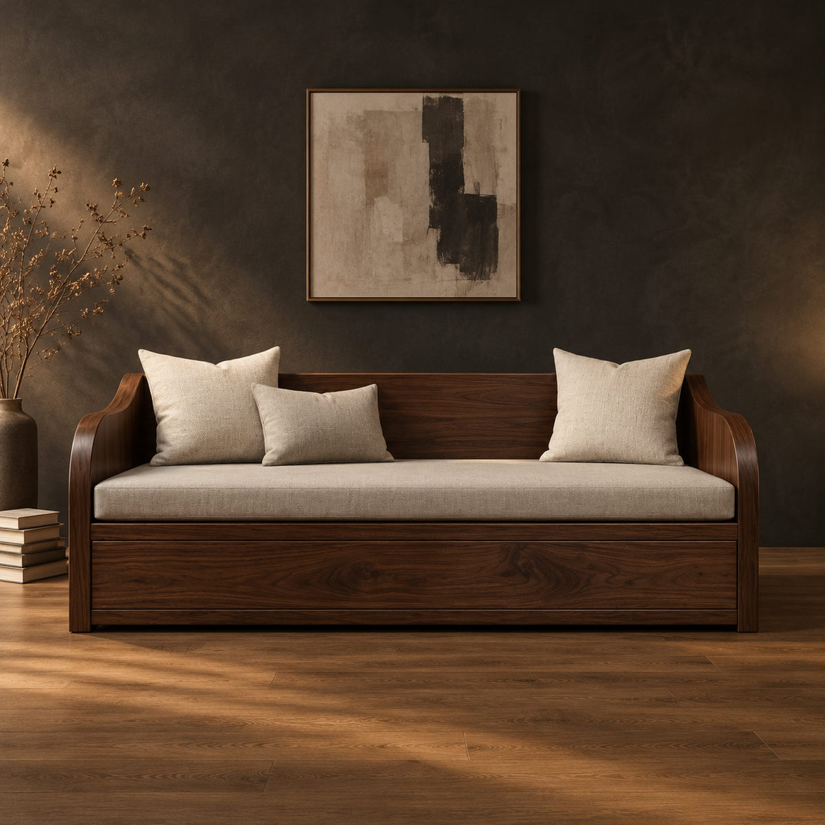 Wood sofa with sweeping arms and a deep paneled base in a dark studio against a charcoal plaster wall