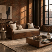 Wood sofa with sweeping arms and a deep paneled base in an industrial loft living room with exposed brick