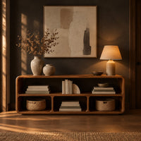 Open console table with soft edges and a long shelf above three cubbies in a dark entryway at golden hour