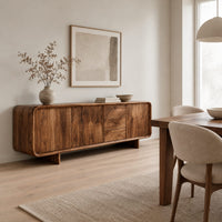 Long low sideboard with soft edges and a drawer stack between doors in a Scandinavian dining room with white walls