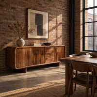 Long low sideboard with soft edges and a drawer stack between doors in an industrial loft dining room with exposed brick