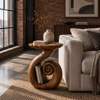 Round side table with a swirling stem and a coiled spiral base in an industrial loft living room with exposed brick
