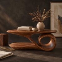 Corner detail of oval coffee table with a top that sweeps into one large spiral curl beside wood, brass and linen samples