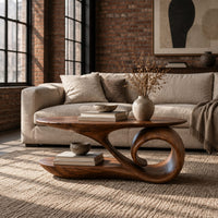 Oval coffee table with a top that sweeps into one large spiral curl in an industrial loft living room with exposed brick