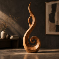 Flame shaped sculpture with an open center and a spiral curl at the base, three-quarter view showing the grain