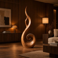 Flame shaped sculpture with an open center and a spiral curl at the base in an evening living room with walnut wall paneling