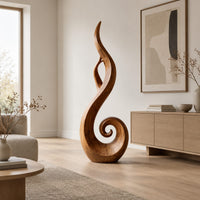 Flame shaped sculpture with an open center and a spiral curl at the base in a Scandinavian living room with white walls