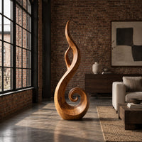 Flame shaped sculpture with an open center and a spiral curl at the base in an industrial loft living room with exposed brick