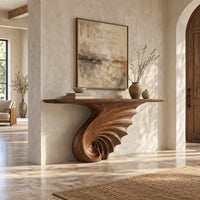 Console table on a single spiral scroll base with fanned carved ridges in a bright open plan entryway