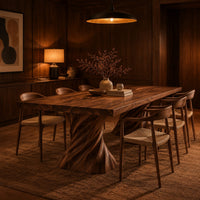 Long dining table on two spiral twisted pedestals with a thick flat top in an evening dining room with walnut wall paneling