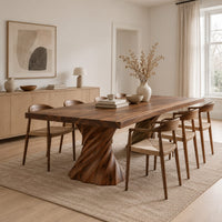 Long dining table on two spiral twisted pedestals with a thick flat top in a Scandinavian dining room with white walls