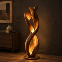 Twisted floor lamp with spiral wood ribbons and a warm inner glow, three-quarter view showing the grain