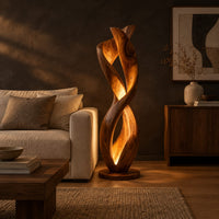 Twisted floor lamp with spiral wood ribbons and a warm inner glow in a dark living room at golden hour