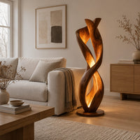 Twisted floor lamp with spiral wood ribbons and a warm inner glow in a Scandinavian living room with white walls
