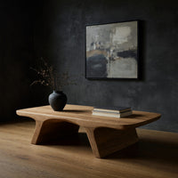 Pale splayed leg coffee table in a dark studio against a charcoal wall