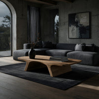 Pale splayed leg coffee table in a concrete and timber loft