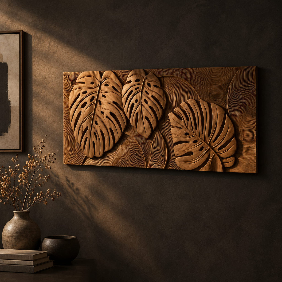 Wood wall art with three carved split leaves in deep relief on a dark charcoal plaster wall