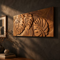 Wood wall art with three carved split leaves in deep relief, three-quarter view showing the carved depth