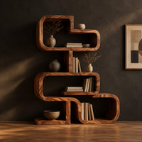 Stacked loop bookshelf with offset open cubbies on a flat base in a dark studio against a charcoal plaster wall