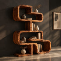 Stacked loop bookshelf with offset open cubbies on a flat base, three-quarter view showing the grain