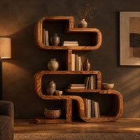 Stacked loop bookshelf with offset open cubbies on a flat base in a dark living room at golden hour