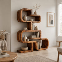 Stacked loop bookshelf with offset open cubbies on a flat base in a Scandinavian living room with white walls