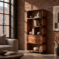 Tall stacked bookshelf of soft edged cubbies with a wide drawer in an industrial loft living room with exposed brick