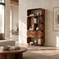 Tall stacked bookshelf of soft edged cubbies with a wide drawer in a bright open plan living room
