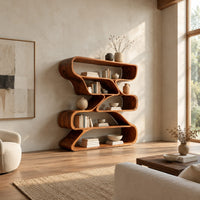 Bookshelf of staggered looping open compartments with soft pill shaped ends in a bright open plan living room