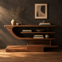 Open shelf console table with staggered shelves on a stepped base in a dark studio against a charcoal plaster wall