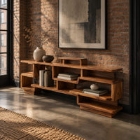 Staggered open shelf console table with interlocking cubbies in an industrial loft entryway with exposed brick