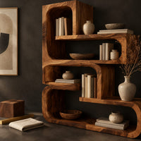Corner detail of stepped bookshelf of chunky open cubbies with offset shelves beside wood, brass and linen samples