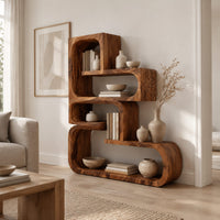 Stepped bookshelf of chunky open cubbies with offset shelves in a Scandinavian living room with white walls