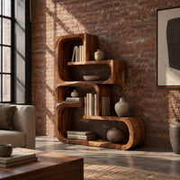 Stepped bookshelf of chunky open cubbies with offset shelves in an industrial loft living room with exposed brick