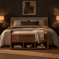 Storage bench with coat pegs, a top shelf, a cushioned seat and open cubbies in a dark bedroom at golden hour