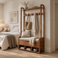 Storage bench with coat pegs, a top shelf, a cushioned seat and open cubbies in a Scandinavian bedroom with white walls