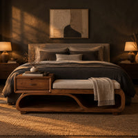 Wood bench with a small drawer and an open wave shaped base in a dark bedroom at golden hour