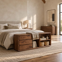 Low storage bench with three stacked drawers and open shelf bays in a bright open plan bedroom