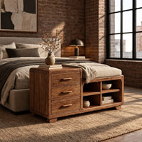 Low wooden bench with three drawers, four open cubbies and a cushioned seat in an industrial loft bedroom with exposed brick